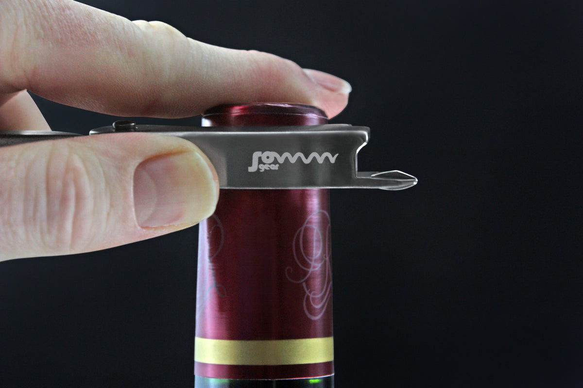 SommGear Vintage 1 wine key and bottle opener cutting the foil on a wine bottle.